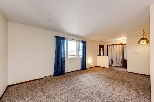 unfurnished room with carpet flooring and baseboards