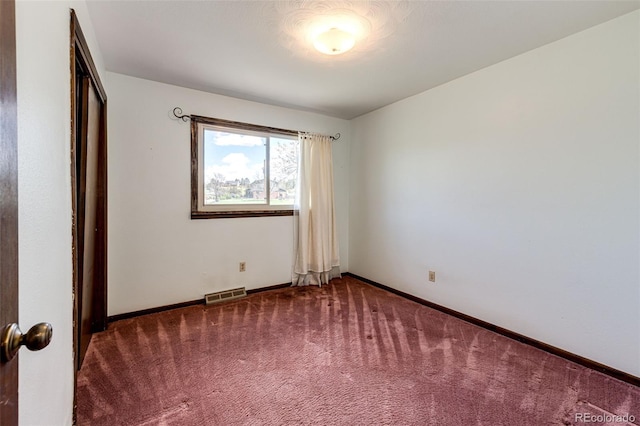 unfurnished bedroom with carpet, baseboards, and a closet