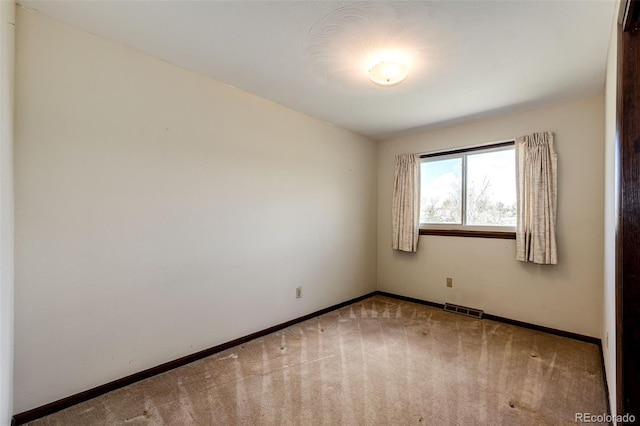 empty room with carpet and baseboards
