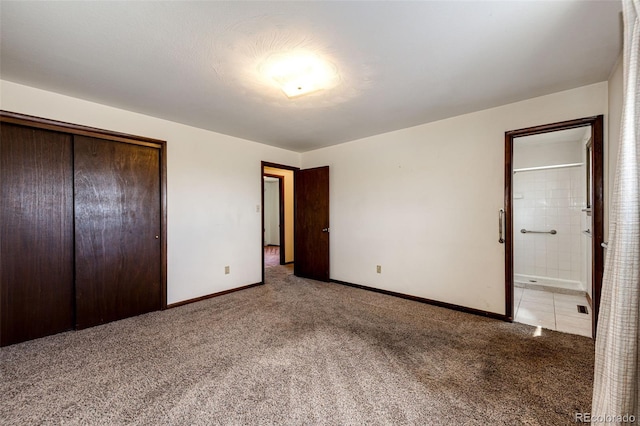 unfurnished bedroom featuring light carpet, baseboards, a closet, and connected bathroom