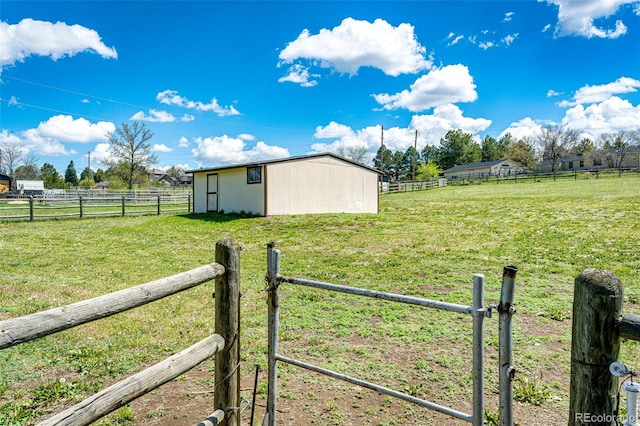 view of yard with a rural view and an outbuilding
