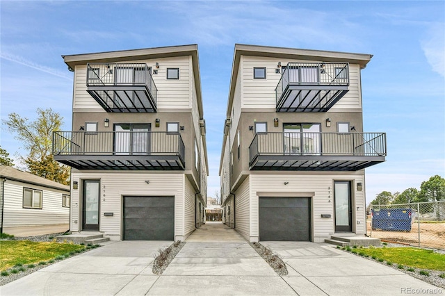 2164 S Ash St, Denver, CO 80222 - contemporary house with a balcony, a garage, concrete driveway, and fence
