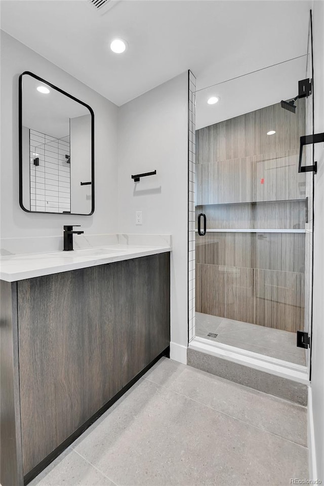 2164 S Ash St, Denver, CO 80222 - full bath featuring a shower stall, recessed lighting, baseboards, and vanity