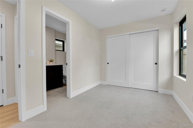 2164 S Ash St, Denver, CO 80222 - unfurnished bedroom featuring light colored carpet, baseboards, and a closet
