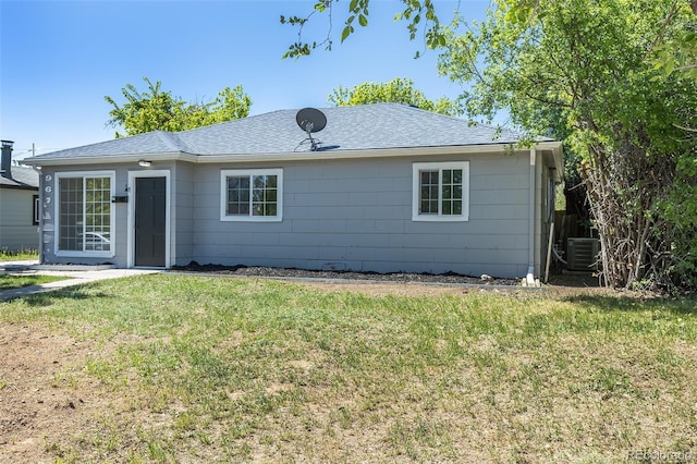 967 Victor St, Aurora, CO 80011 - back of house with a lawn, central AC unit, and a shingled roof