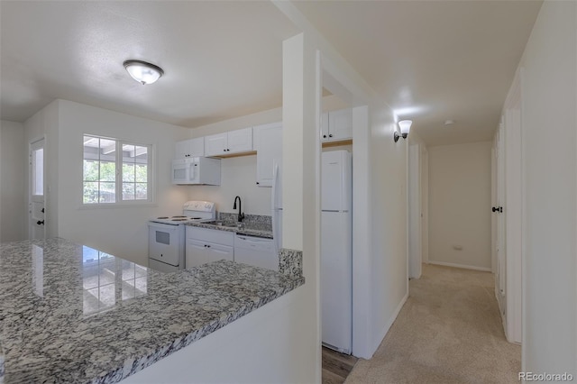 967 Victor St, Aurora, CO 80011 - kitchen featuring white appliances, white cabinets, a sink, and baseboards