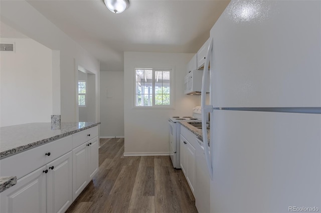 967 Victor St, Aurora, CO 80011 - kitchen featuring white appliances, white cabinets, dark wood finished floors, and baseboards