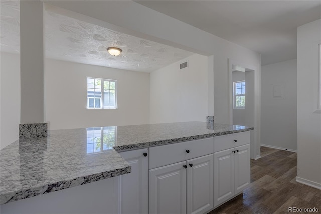 967 Victor St, Aurora, CO 80011 - kitchen with dark wood-style floors, white cabinetry, and baseboards