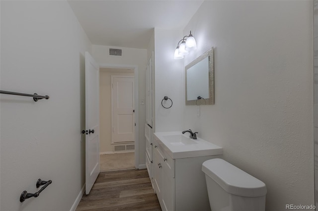 967 Victor St, Aurora, CO 80011 - bathroom featuring wood finished floors, vanity, and toilet