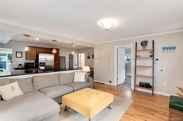 3175 S Pennsylvania St, Englewood, CO 80113 - living area featuring light wood-type flooring, crown molding, and baseboards