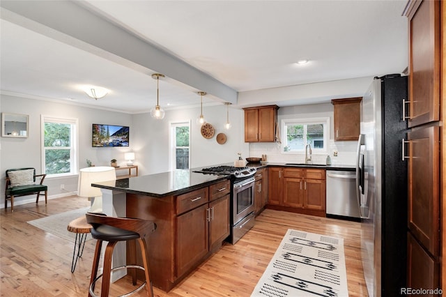 3175 S Pennsylvania St, Englewood, CO 80113 - kitchen with appliances with stainless steel finishes, light wood-type flooring, a sink, tasteful backsplash, and crown molding