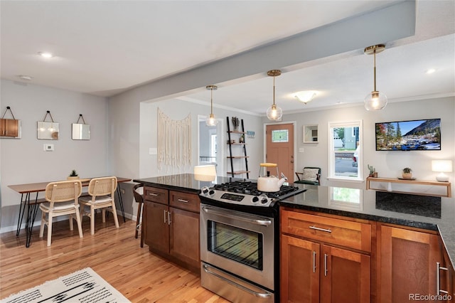 3175 S Pennsylvania St, Englewood, CO 80113 - kitchen with stainless steel gas range oven, light wood-type flooring, ornamental molding, pendant lighting, and baseboards