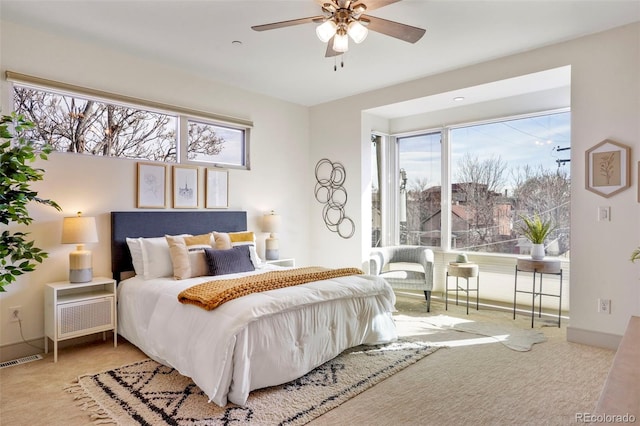 bedroom with a ceiling fan, carpet flooring, visible vents, and baseboards