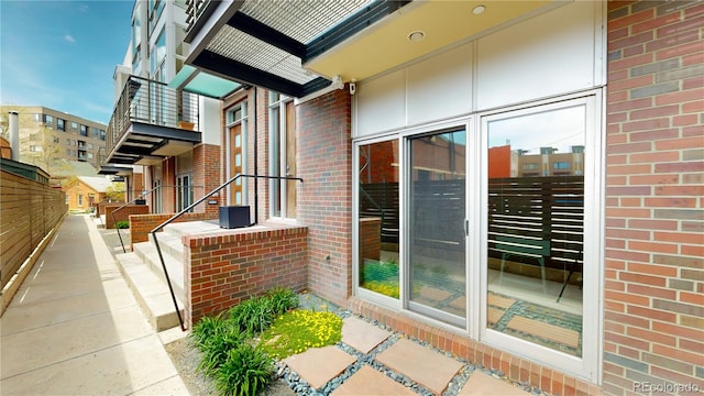 entrance to property featuring brick siding