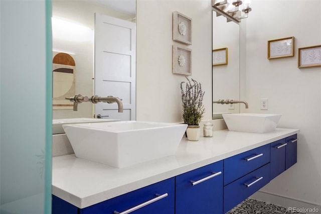 full bathroom featuring double vanity and a sink