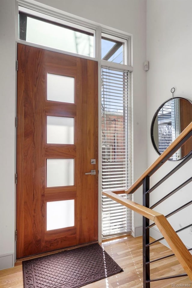 entryway with stairway and light wood finished floors