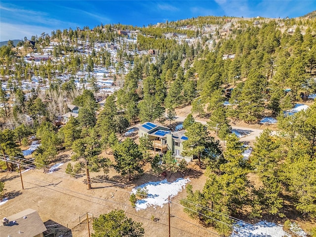 birds eye view of property with a view of trees