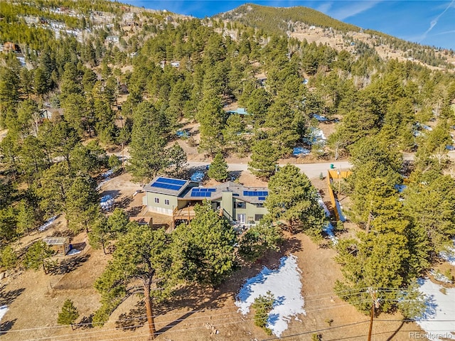 birds eye view of property featuring a wooded view and a mountain view