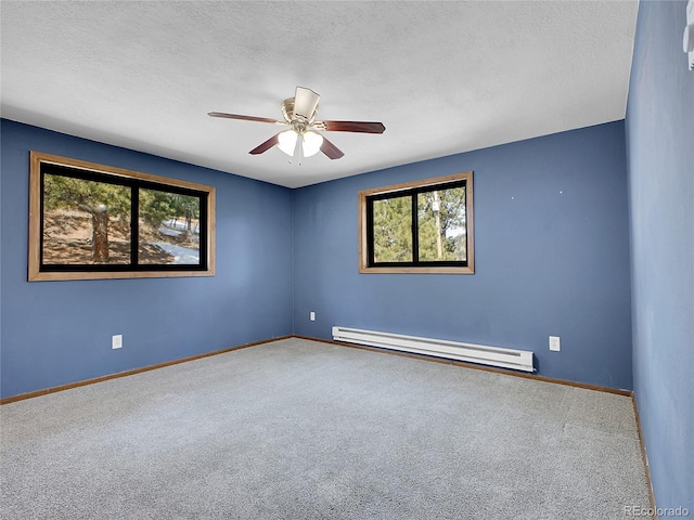 carpeted spare room with a baseboard radiator, baseboards, a textured ceiling, and ceiling fan