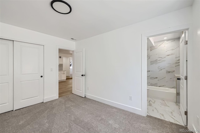 2823 W Archer Pl, Denver, CO 80219 - unfurnished bedroom featuring a closet, carpet, baseboards, and connected bathroom