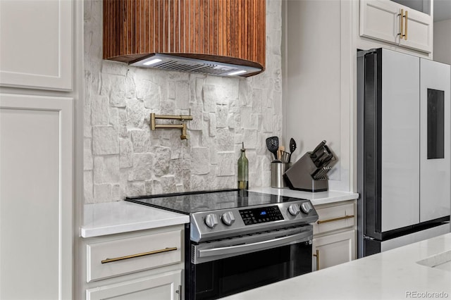 690 S Newark Ct, Aurora, CO 80012 - kitchen with freestanding refrigerator, backsplash, stainless steel range with electric cooktop, and light countertops
