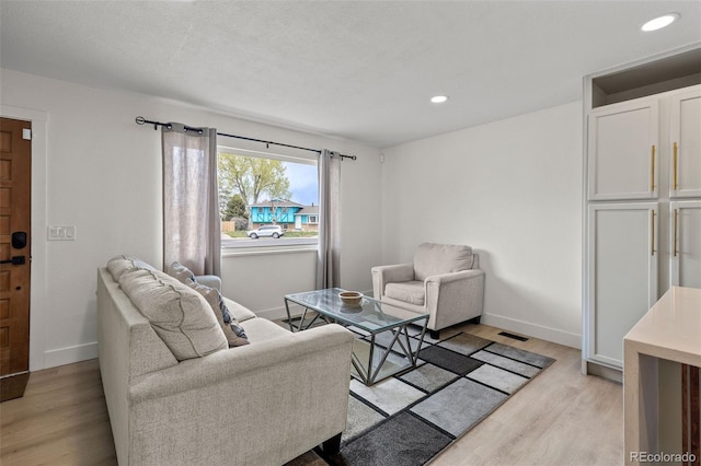 690 S Newark Ct, Aurora, CO 80012 - living area featuring recessed lighting, baseboards, visible vents, and light wood-type flooring