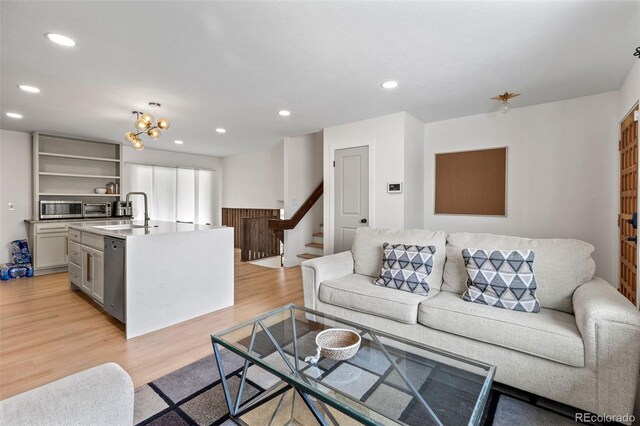 690 S Newark Ct, Aurora, CO 80012 - living room with stairway, light wood-style floors, and recessed lighting