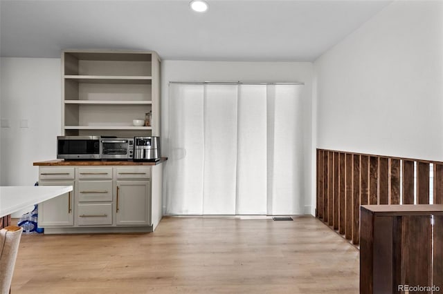 690 S Newark Ct, Aurora, CO 80012 - kitchen with stainless steel microwave, recessed lighting, light wood-style flooring, and visible vents