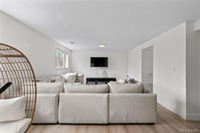 690 S Newark Ct, Aurora, CO 80012 - living room featuring baseboards, wood finished floors, and visible vents