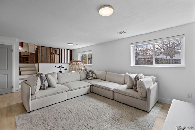 690 S Newark Ct, Aurora, CO 80012 - living area featuring stairway, visible vents, baseboards, and light wood finished floors