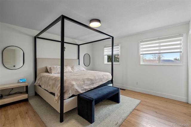 690 S Newark Ct, Aurora, CO 80012 - bedroom with baseboards and wood finished floors