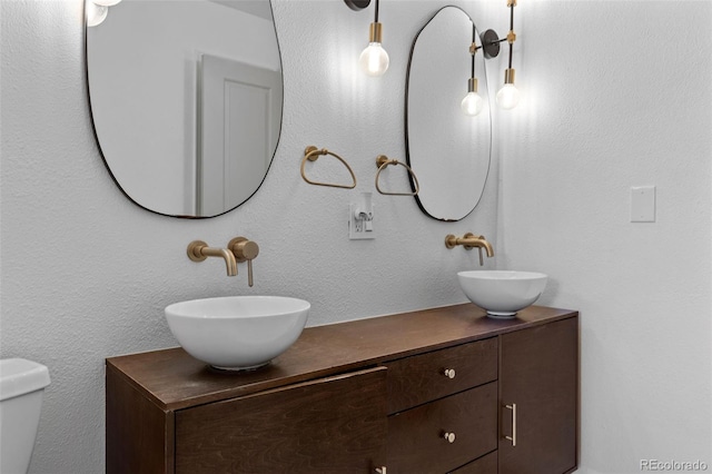 690 S Newark Ct, Aurora, CO 80012 - bathroom with double vanity, a sink, and toilet