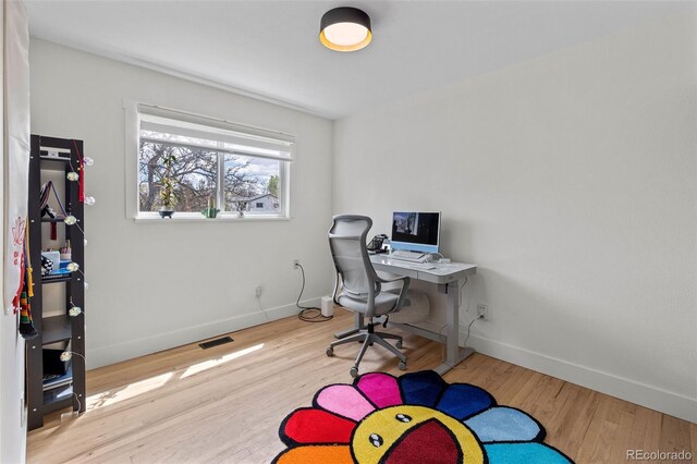 690 S Newark Ct, Aurora, CO 80012 - office area featuring baseboards, visible vents, and wood finished floors