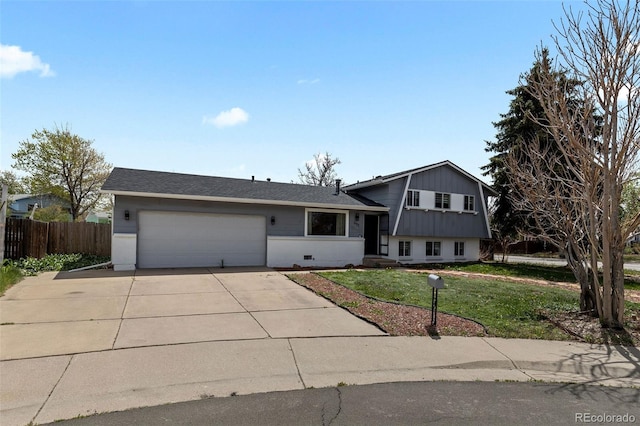 690 S Newark Ct, Aurora, CO 80012 - tri-level home featuring fence, driveway, a front yard, and a garage