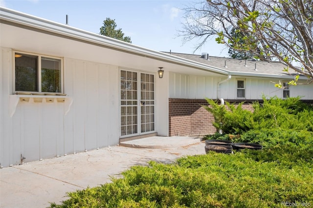 12940 W 75th Ave, Arvada, CO 80005 - rear view of house with brick siding, a patio, and board and batten siding