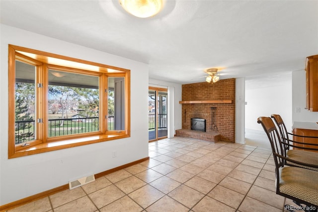 12940 W 75th Ave, Arvada, CO 80005 - unfurnished living room featuring a ceiling fan, light tile patterned flooring, baseboards, and a brick fireplace