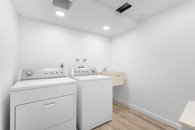 12940 W 75th Ave, Arvada, CO 80005 - laundry area featuring washer and dryer, light wood-style floors, baseboards, and recessed lighting