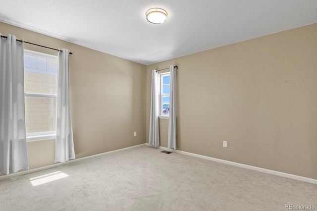 empty room with carpet and baseboards