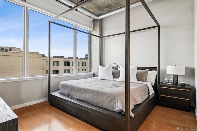 1401 Wewatta St Unit 911, Denver, CO 80202 - bedroom featuring wood finished floors and baseboards