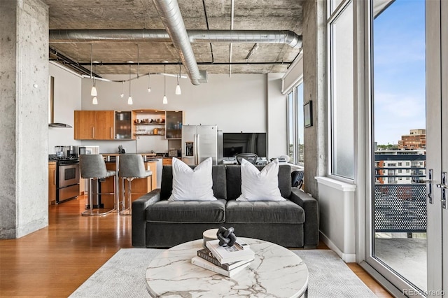 1401 Wewatta St Unit 911, Denver, CO 80202 - living area with light wood finished floors and a high ceiling