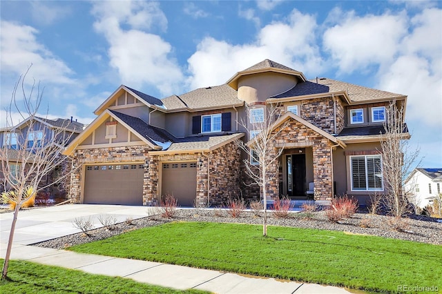 view of front of home featuring a garage and a front yard