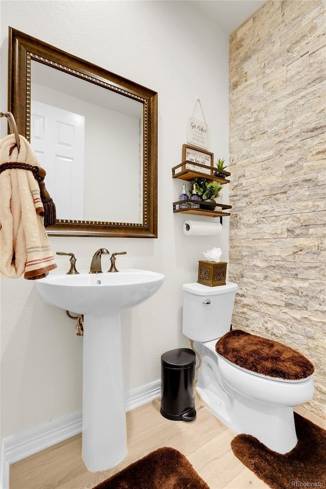 bathroom featuring wood-type flooring and toilet