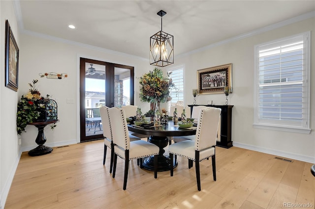 dining room featuring crown molding, a notable chandelier, and light hardwood / wood-style floors