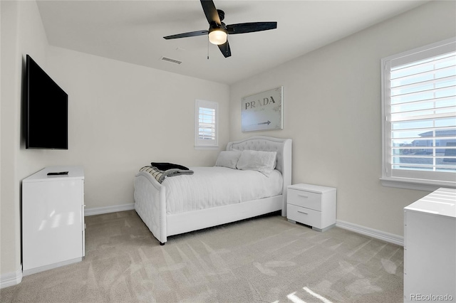 bedroom featuring ceiling fan and light carpet