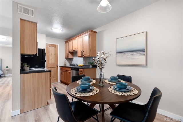 16359 W 10th Ave Unit T1, Golden, CO 80401 - dining room with light wood-style flooring and baseboards