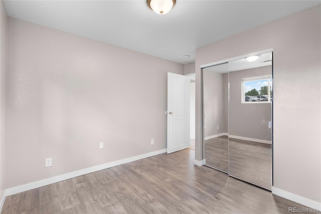 16359 W 10th Ave Unit T1, Golden, CO 80401 - unfurnished bedroom with wood finished floors, a closet, and baseboards