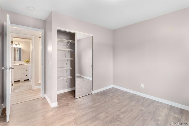 16359 W 10th Ave Unit T1, Golden, CO 80401 - unfurnished bedroom with light wood-type flooring, baseboards, and a closet