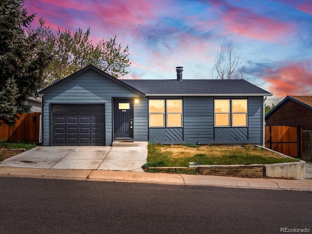 single story home featuring a garage, fence, driveway, and roof with shingles