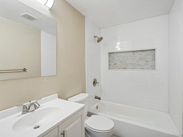 bathroom featuring visible vents, vanity, a textured wall, toilet, and washtub / shower combination