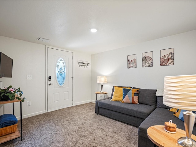 living area featuring baseboards, carpet, and visible vents